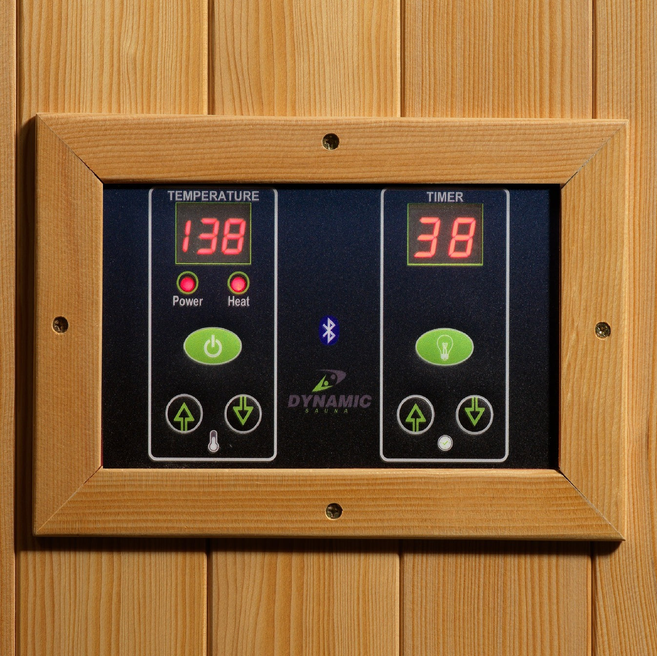 Digital control panel with temperature and timer display on a wooden background